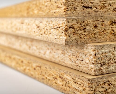 particleboard made stronger with reinforcement and anchoring adhesive