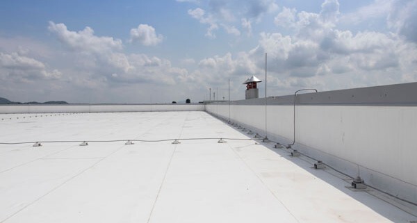 White PVC roofing membrane on flat industrial roof